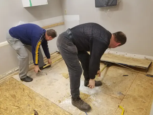 Crew installing a new subfloor