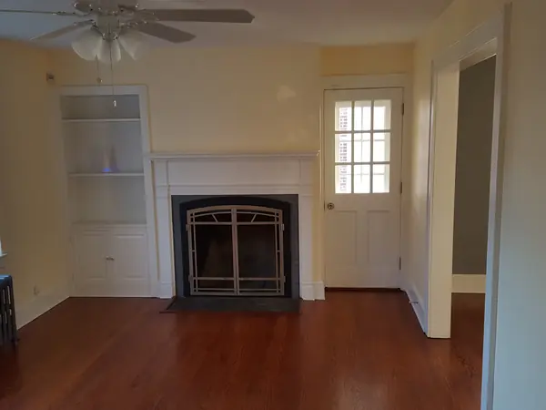 Finished living room with fireplace and hardwood floors